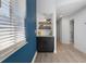 Stylish bar area with storage and shelves in a well-lit hallway at 500 New York Ave # 23, Dunedin, FL 34698
