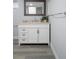 Modern bathroom with vanity, framed mirror, gray flooring, and ample storage at 500 New York Ave # 23, Dunedin, FL 34698