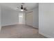 Bedroom with neutral carpet, a ceiling fan, and a closet with sliding doors at 500 New York Ave # 23, Dunedin, FL 34698