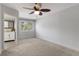 Spacious bedroom with neutral carpet, ceiling fan, and ensuite bathroom with modern updates at 500 New York Ave # 23, Dunedin, FL 34698