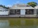Waterfront house with screened in back porch overlooking the water on a sunny day at 500 New York Ave # 23, Dunedin, FL 34698