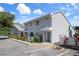 Two-story townhome features neutral siding, well-maintained landscaping, and convenient parking at 500 New York Ave # 23, Dunedin, FL 34698