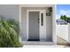 Stylish gray front door with sidelight and modern lock system provides secure and convenient access at 500 New York Ave # 23, Dunedin, FL 34698