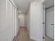 Bright hallway with wood-look flooring, closet and access to other rooms at 500 New York Ave # 23, Dunedin, FL 34698