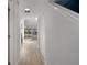 Bright hallway with wood-look flooring leading to the living area with water views at 500 New York Ave # 23, Dunedin, FL 34698