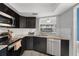 Modern kitchen featuring stainless steel appliances, granite countertops, and a breakfast bar at 500 New York Ave # 23, Dunedin, FL 34698