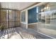 Screened-in lanai with gray tile flooring, and access to the home interior at 500 New York Ave # 23, Dunedin, FL 34698