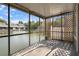 Screened-in lanai overlooking a pond with water feature, and a white picket fence at 500 New York Ave # 23, Dunedin, FL 34698