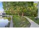 Scenic walking path along the water featuring lush trees and vegetation at 500 New York Ave # 23, Dunedin, FL 34698