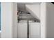 Bright laundry closet featuring side-by-side washer and dryer on shelves at 500 New York Ave # 23, Dunedin, FL 34698