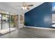 Bright living room featuring wood floors, a ceiling fan, and sliding glass doors to a screened patio with water view at 500 New York Ave # 23, Dunedin, FL 34698
