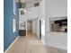 Bright living room featuring wood floors, a ceiling fan, and a view into the hallway and kitchen at 500 New York Ave # 23, Dunedin, FL 34698