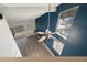 Bright open loft featuring high ceilings, modern ceiling fans, and blue accent wall at 500 New York Ave # 23, Dunedin, FL 34698