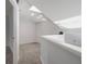 Bright loft space with railing overlooking below, neutral carpet, and skylight at 500 New York Ave # 23, Dunedin, FL 34698
