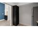 Hallway pantry near kitchen with dark wood cabinets and stainless steel refrigerator at 500 New York Ave # 23, Dunedin, FL 34698