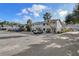 Exterior view showcasing a well-maintained parking area with lush landscaping at 500 New York Ave # 23, Dunedin, FL 34698