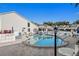 Community pool with plenty of seating and lounge chairs on a sunny day at 500 New York Ave # 23, Dunedin, FL 34698