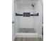 Bathroom features a walk-in shower with blue accent tiles and modern shower head at 500 New York Ave # 23, Dunedin, FL 34698