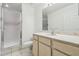 Well-lit bathroom with a glass-enclosed shower and a vanity with a marble countertop at 5052 Sunridge Palms Dr # 102, Tampa, FL 33617