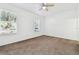 Carpeted bedroom with a ceiling fan and two windows that provide natural light at 5052 Sunridge Palms Dr # 102, Tampa, FL 33617