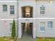 A three-story condo building showing front entrance with covered access and stairs to upper floors at 5052 Sunridge Palms Dr # 102, Tampa, FL 33617