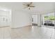 Bright living room with tile floors, ceiling fan, and sliding glass doors to the outside at 5052 Sunridge Palms Dr # 102, Tampa, FL 33617