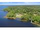 Beautiful aerial view of a lakeside community offering stunning waterfront scenery and lush greenery at 5160 Loquat Ct, Palm Harbor, FL 34685