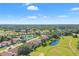 Aerial view of the community showcasing well-maintained homes, ponds, golf course, and mature trees at 5160 Loquat Ct, Palm Harbor, FL 34685
