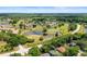 Overhead shot of a golf course community with winding ponds and lush green fairways at 5160 Loquat Ct, Palm Harbor, FL 34685