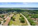 An aerial shot captures the neighborhood with a beautiful lake view and well-maintained green spaces at 5160 Loquat Ct, Palm Harbor, FL 34685