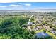 Scenic aerial view highlights a property's location near lush greenery, tranquil lakes and neighborhood at 5160 Loquat Ct, Palm Harbor, FL 34685