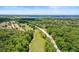 Aerial view of a golf course, lakes, and homes, offering scenic views and a sense of community at 5160 Loquat Ct, Palm Harbor, FL 34685