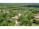 Wide aerial view of a community featuring pool, playground, trees and green spaces at 5160 Loquat Ct, Palm Harbor, FL 34685