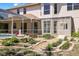 Serene backyard featuring a screened patio, lush landscaping, and a stone fountain, perfect for outdoor living at 5160 Loquat Ct, Palm Harbor, FL 34685