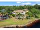 Scenic backyard with a pool, lush palm trees, and a serene lake view, creating a private oasis at 5160 Loquat Ct, Palm Harbor, FL 34685