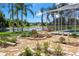 Lush backyard with stone patio and scenic lake view at 5160 Loquat Ct, Palm Harbor, FL 34685