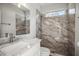 Modern bathroom with stylish marble tile, glass shower, and elegant fixtures at 5160 Loquat Ct, Palm Harbor, FL 34685