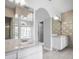 Bathroom with tiled countertops, large mirrors, and cabinets, providing lots of storage space at 5160 Loquat Ct, Palm Harbor, FL 34685