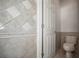 Tiled bathroom featuring a toilet and tile accents at 5160 Loquat Ct, Palm Harbor, FL 34685