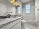 Bright bathroom featuring a granite vanity, a soaking tub, white tiling, and natural light at 5160 Loquat Ct, Palm Harbor, FL 34685
