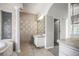 Spacious bathroom boasts elegant column, large mirror, and tiled floors at 5160 Loquat Ct, Palm Harbor, FL 34685