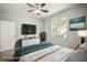Well-lit bedroom featuring a ceiling fan, a TV, and neutral decor for a relaxing atmosphere at 5160 Loquat Ct, Palm Harbor, FL 34685