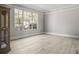 Bright bedroom with a large window offering a view of the surrounding greenery at 5160 Loquat Ct, Palm Harbor, FL 34685