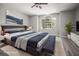 Stylish bedroom with a large window, modern decor, and a cozy seating area for a tranquil retreat at 5160 Loquat Ct, Palm Harbor, FL 34685
