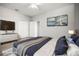 Contemporary bedroom features a TV, closet and calming color palette for a peaceful sanctuary at 5160 Loquat Ct, Palm Harbor, FL 34685
