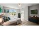 Bright bedroom with a large window providing natural light, modern furnishings, and tranquil decor at 5160 Loquat Ct, Palm Harbor, FL 34685