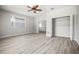 Spacious bedroom featuring wooden floors, an open closet, natural lighting, and neutral gray walls at 5160 Loquat Ct, Palm Harbor, FL 34685