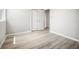 Bedroom with wood-look floors, closet with double doors, and neutral paint at 5160 Loquat Ct, Palm Harbor, FL 34685