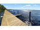 Community dock on the lake with wooden planks and views of the sparkling water at 5160 Loquat Ct, Palm Harbor, FL 34685