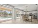 Dining area with chandelier near the kitchen and views of the backyard pool at 5160 Loquat Ct, Palm Harbor, FL 34685